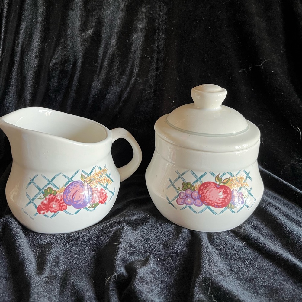 Treasure Craft Pottery creamer and covered sugar.  Decorated with fruit c1984